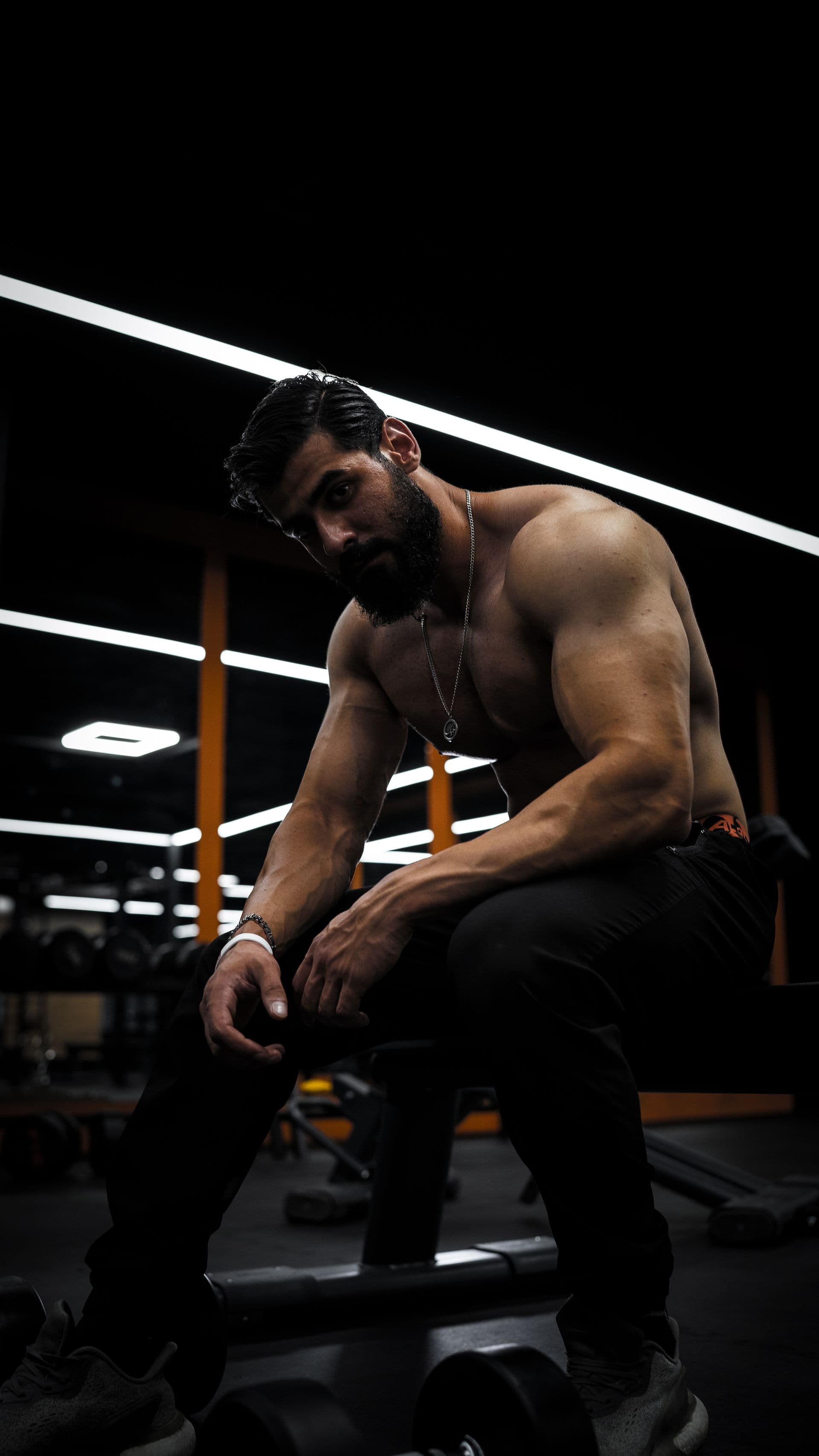 Athlete resting between sets with focused intensity