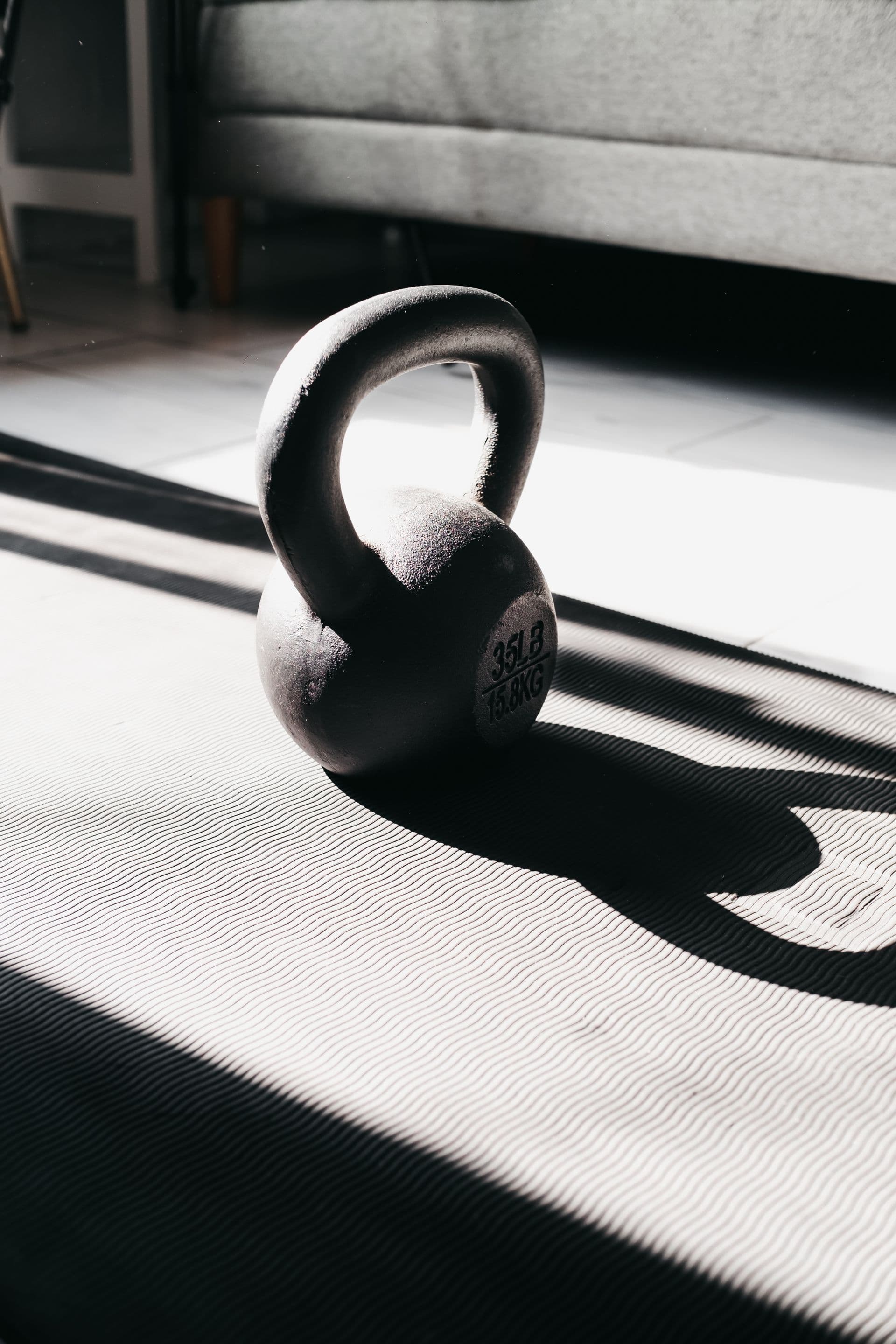 Kettlebell resting on a mat in natural light